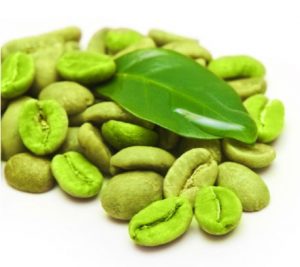 Green coffee beans with leaves on white background.